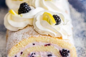 Fluffy and moist Blackberry Lemon Cake Roll (Swiss Roll) that's easier than you think! Impress everyone with this show-stopping Blackberry Lemon Cake Roll | natashaskitchen.com