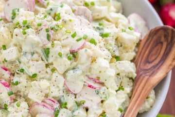 The most flavorful creamy potato salad recipe! This potato salad is loaded with fresh cucumber and radish - lighter and satisfying! Excellent and easy potato salad recipe | natashaskitchen.com #potatosalad #potatosaladrecipe #howtomakepotatosalad #potatoes