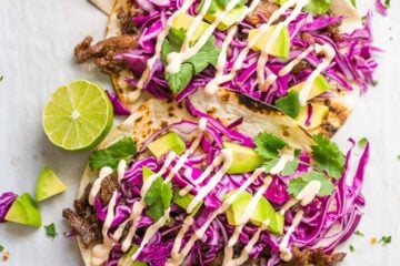 Fully loaded Korean Beef Tacos with flavorful Beef Bulgogi. Don't skip the best taco sauce! Every bite of these Korean Beef Tacos is a flavor explosion! | natashaskitchen.com