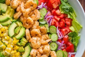 Shrimp Cobb Salad with a chopped romaine base layered with shrimp, avocado, and tomatoes