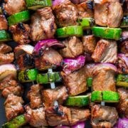 These grilled steak kebabs are juicy and mouthwatering-delicious! It marinates overnight which makes the steak kebabs tender and so flavorful. | natashaskitchen.com