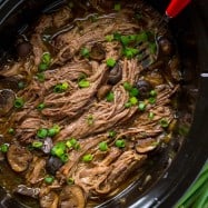 Slow Cooker Beef Brisket is fall-apart tender, juicy, flavorful and easy! The only Slow Cooked beef brisket recipe you'll need! Serve as a side or in a bun. | natashaskitchen.com