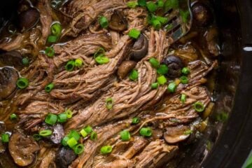 Slow Cooker Beef Brisket is fall-apart tender, juicy, flavorful and easy! The only Slow Cooked beef brisket recipe you'll need! Serve as a side or in a bun. | natashaskitchen.com