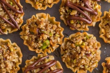 Mini Baklava Cups taste like authentic baklava but easier! The honey and lemon syrup make these baklava cups completely irresistible. A make-ahead recipe! | natashaskitchen.com