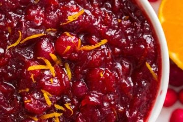 Cranberry sauce recipe served in bowl garnished with orange zest
