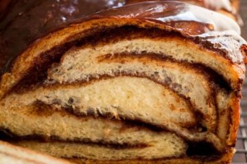 Close up of chocolate babka with a slice cut from the end.