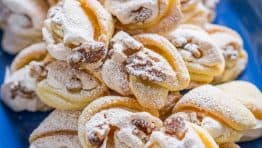 Meringue Shell Cookies have a crisp ribbon of meringue and soft crumbly center. These walnut meringue cookies are completely irresistible Christmas cookies! | natashaskitchen.com