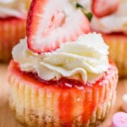 Mini strawberry cheesecakes are easy to make with simple ingredients. The texture in this strawberry cheesecake recipe is is creamy and smooth with a buttery crust. The fresh strawberry topping is irresistible. Valentine&rsquo;s Day Dessert! | natashaskitchen.com