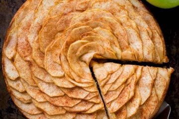 This Apple Tart is a looker! It's crowned with a beautiful rose pattern of sliced apples (and it's easier than you think!). The juices from the cinnamon-sugar coated apple slices, bake into the buttery soft crust. This apple rose tart is lightly sweet and completely irresistible. | natashaskitchen.com