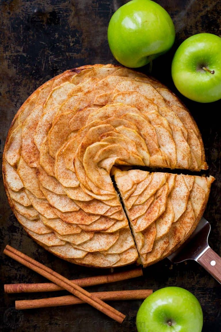 This Apple Tart is a looker! It's crowned with a beautiful rose pattern of sliced apples (and it's easier than you think!). The juices from the cinnamon-sugar coated apple slices, bake into the buttery soft crust. This apple rose tart is lightly sweet and completely irresistible. | natashaskitchen.com
