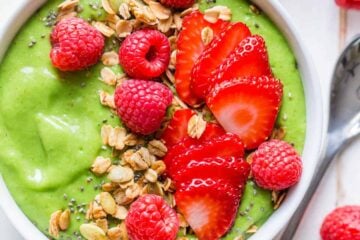 Green smoothie bowl garnished with berries