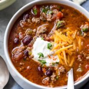 A bowl of Beef chili in a bowl with a spoon