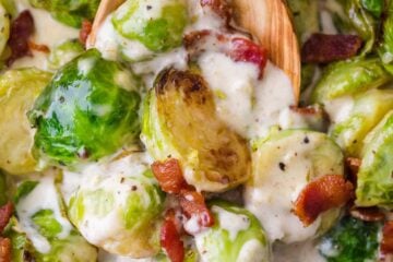Brussels Sprouts in a creamy parmesan garlic alfredo sauce topped with crisp bacon. Quick and easy, holiday-worthy Brussel Sprouts recipe that comes together in one-pan! #brusselsprouts #brusselssprouts #alfredobrusselsprouts #howtocookbrusselsprouts #natashaskitchen