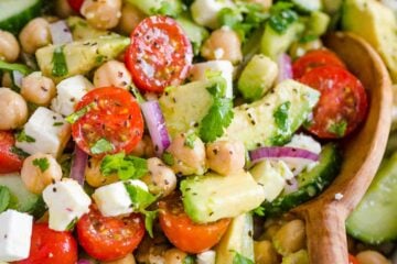 Chickpea Salad loaded with crisp cucumbers, juicy tomatoes, creamy avocado, feta cheese and chickpeas or garbanzo beans. Fresh, healthy and protein packed! #chickpeasalad #garbanzobeansalad #chickpeas #chickpeasaladrecipe #salad #saladrecipe #fetacheese #tomatosalad #avocadosalad #greeksalad #mediterraneansalad #natashaskitchen