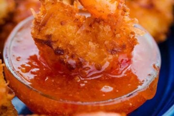 Dipping coconut shrimp in sauce