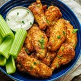 Air Fryer Chicken Wings served with celery sticks and dipping sauce