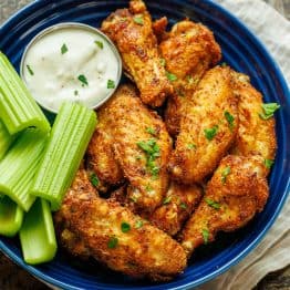 Air Fryer Chicken Wings served with celery sticks and dipping sauce