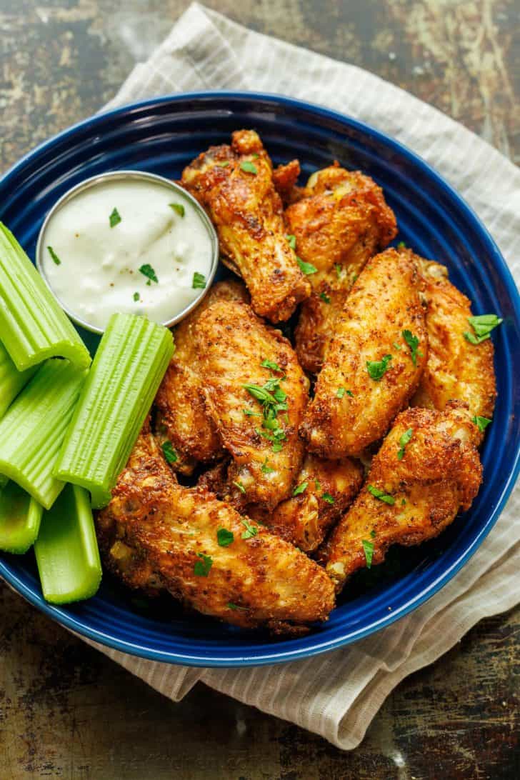 Air Fryer Chicken Wings served with celery sticks and dipping sauce