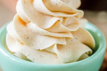 Honey butter in a blue bowl with honey stick