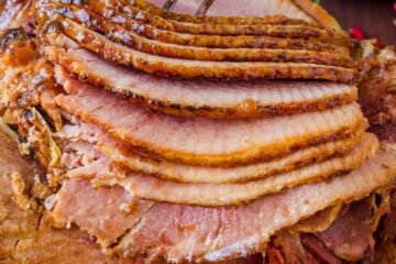 Baked Ham with apricot brown sugar honey glaze on platter