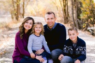 Natasha Kravchuk and with husband and two children posing for the camera.