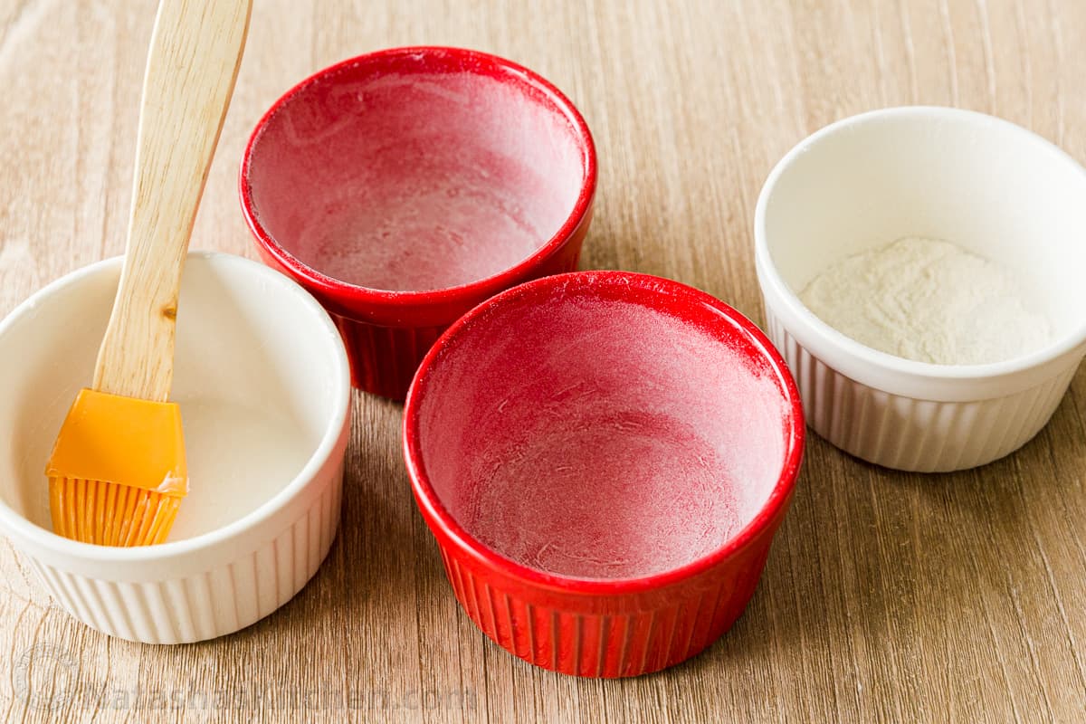 Preparing ramekins with butter and flour
