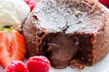 Chocolate Lava cake dusted with powdered sugar with molten center and served with ice cream and berries