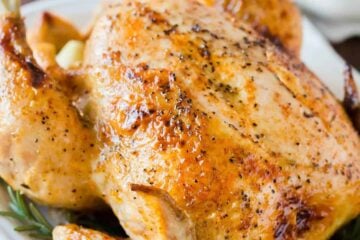 Whole chicken cooked in the instant pot served on a platter with gravy