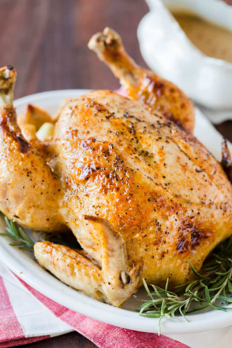 Whole chicken cooked in the instant pot served on a platter with gravy