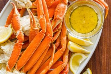 Crab legs served on platter with butter dipping sauce