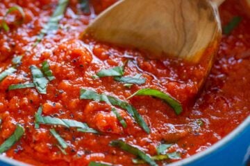 Marinara Sauce in Saucepan garnished with basil for Italian marinara