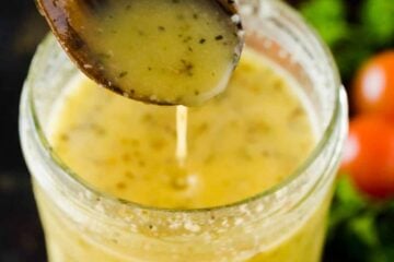 Italian dressing pouring from serving spoon