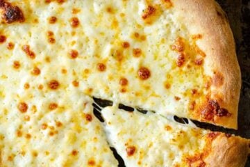 Pizza dough baked with cheese and white sauce