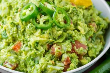 Spicy guacamole garnished with jalapeno peppers