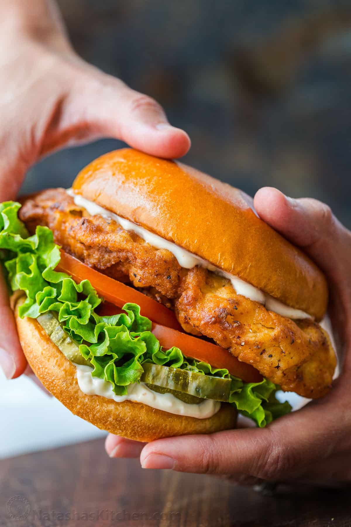 Crispy chicken sandwich on a bun with sauce and toppings