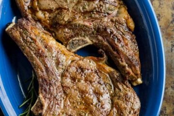 Grilled Steak on blue platter served with chimichurri sauce