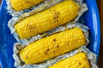 Grilled Corn in Foil on a blue platter