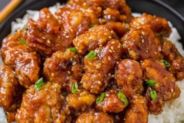 General tsos chicken served over a bowl of white rice