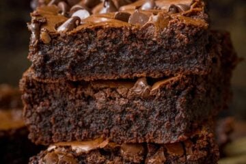 fudgy brownies stacked on parchment paper