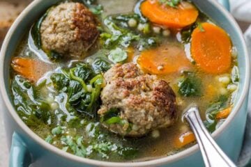 Italian Wedding Soup in a bowl with a spoon