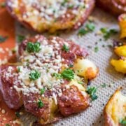 Crispy smashed potatoes on baking sheet with cheesy crust