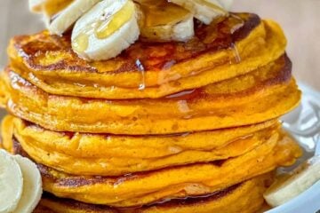 Pumpkin pancakes stacked on a plate