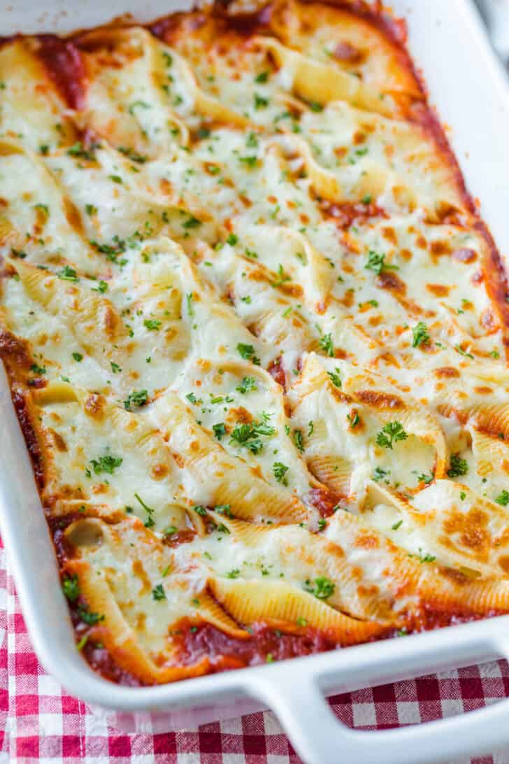 Stuffed pasta shells in casserole garnished with parsley