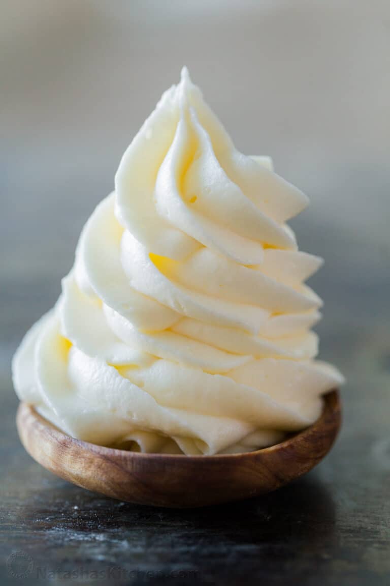 Cream cheese frosting piped onto spoon