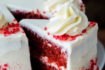 Red Velvet Cake sliced with one piece being served