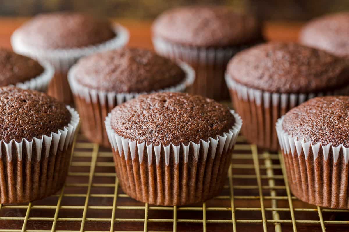 Easy Chocolate Cupcake recipe with bakery results at home! This cupcake is chocolatey, moist, perfectly domed, and incredibly easy! Domed mini cakes baked and ready for freezing.