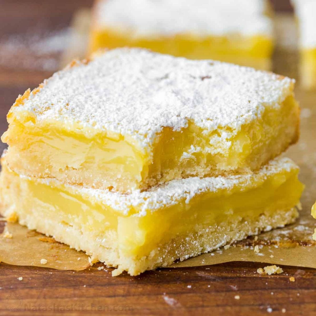 Lemon bars stacked and dusted with sugar