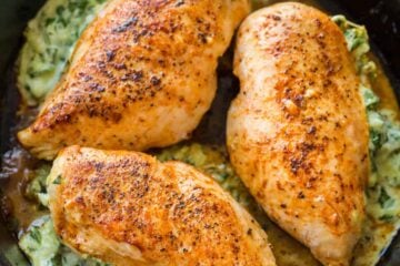 Spinach stuffed chicken breasts in skillet