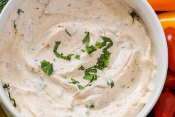 Veggie dip surrounded by fresh vegetables