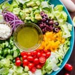 Chopped Greek Salad with lettuce recipe in a bowl with dressing